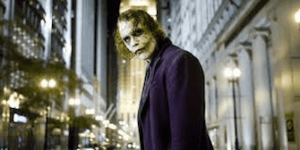 joker looksup at someone in the street in the dark knight